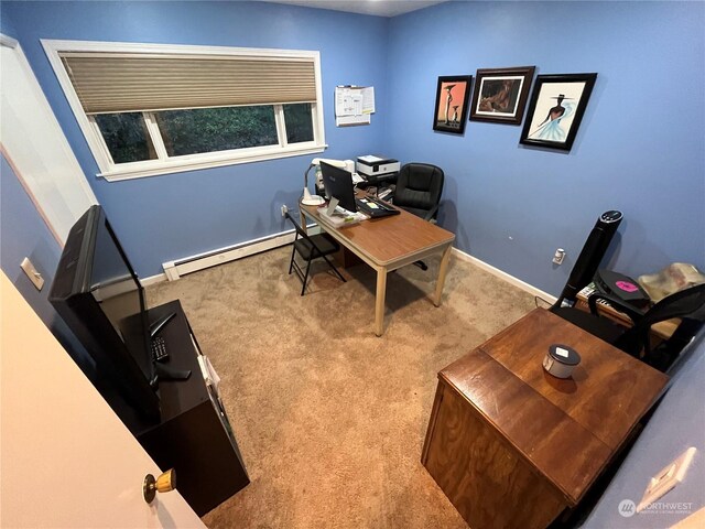 carpeted office space with baseboard heating