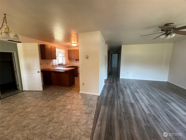 kitchen with ceiling fan with notable chandelier and hardwood / wood-style floors