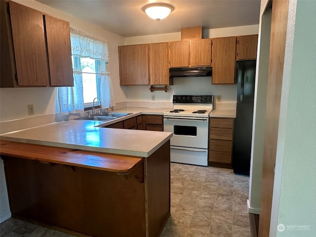 kitchen featuring black refrigerator, white range with electric cooktop, kitchen peninsula, and sink