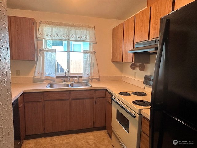 kitchen featuring white range with electric cooktop, black refrigerator, and sink