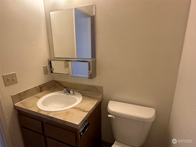 bathroom with toilet and vanity