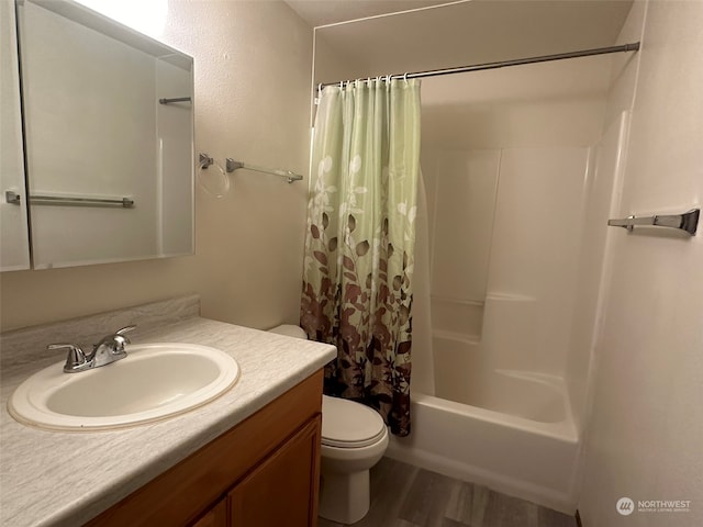 full bathroom featuring shower / bath combo, hardwood / wood-style floors, toilet, and vanity