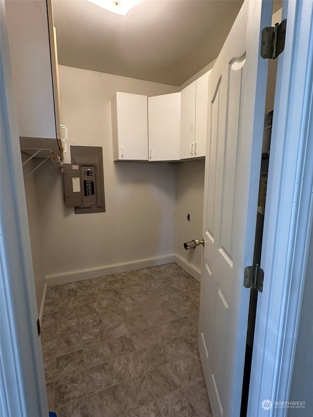 laundry room featuring cabinets and electric panel