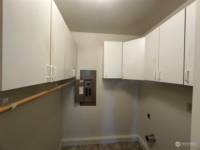 laundry room featuring cabinets, electric panel, and electric dryer hookup