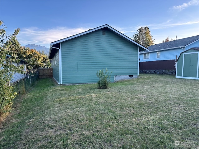 view of home's exterior featuring a lawn and a shed