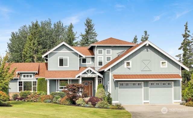 view of front of house featuring a garage and a front lawn