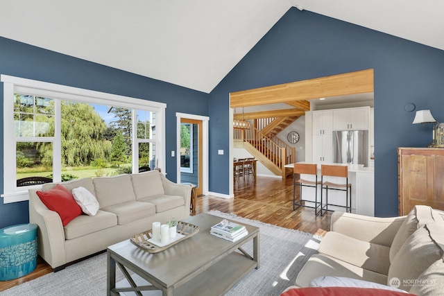 living room featuring hardwood / wood-style floors and high vaulted ceiling