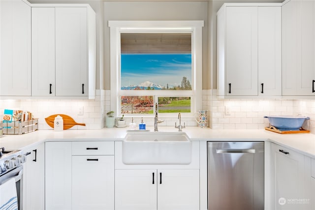 kitchen with white cabinets, appliances with stainless steel finishes, decorative backsplash, and sink