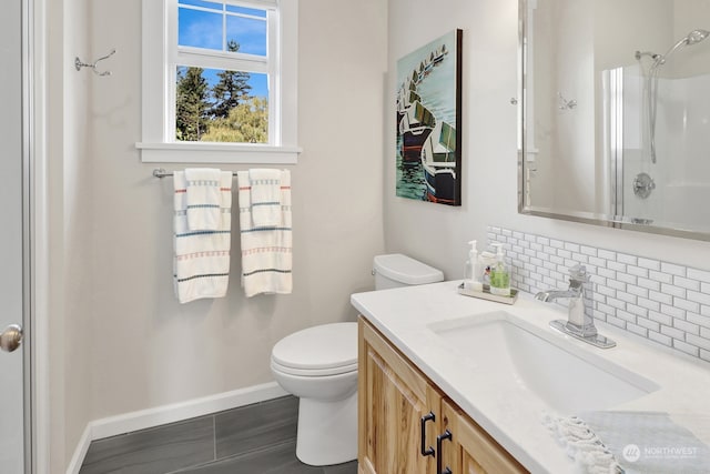 bathroom with a shower, toilet, and vanity