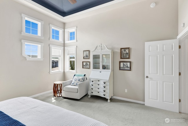 carpeted bedroom with ceiling fan and a high ceiling