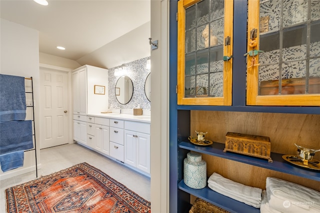 bathroom with lofted ceiling and vanity