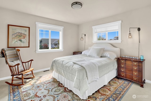 carpeted bedroom featuring multiple windows