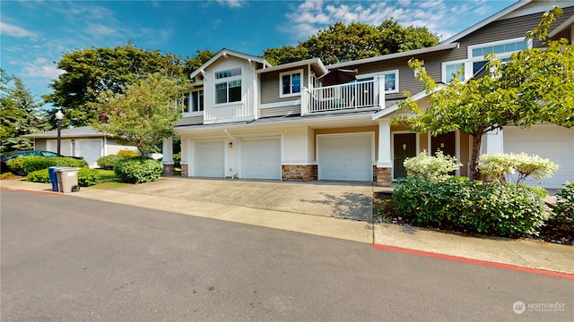 view of front of property featuring a balcony and a garage