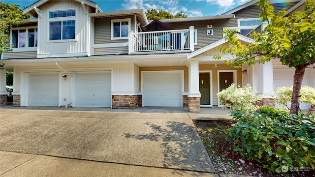 townhome / multi-family property featuring a garage and a balcony