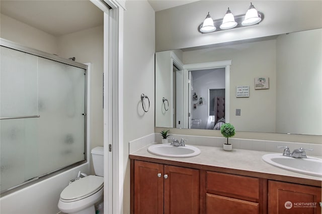 full bathroom featuring vanity, toilet, and enclosed tub / shower combo