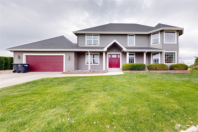 view of front of home with a front yard and a garage