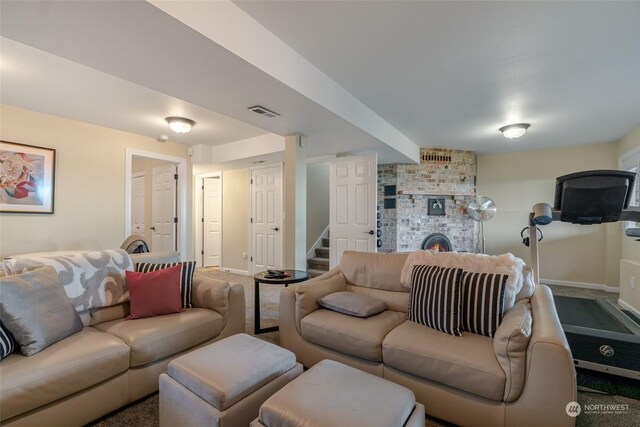 living room with a brick fireplace and carpet floors