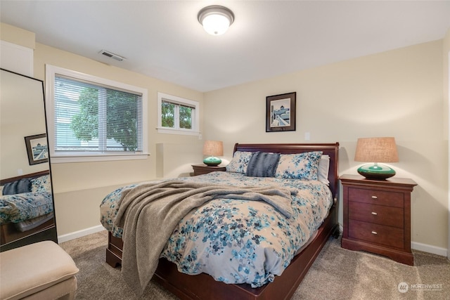 bedroom with carpet floors, baseboards, and visible vents