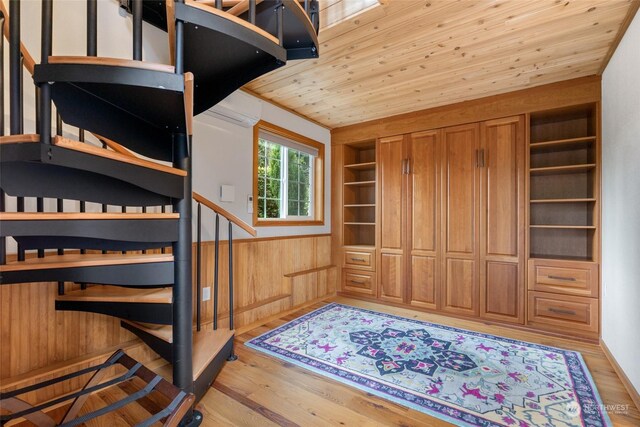 interior space featuring wooden ceiling, hardwood / wood-style flooring, and wood walls