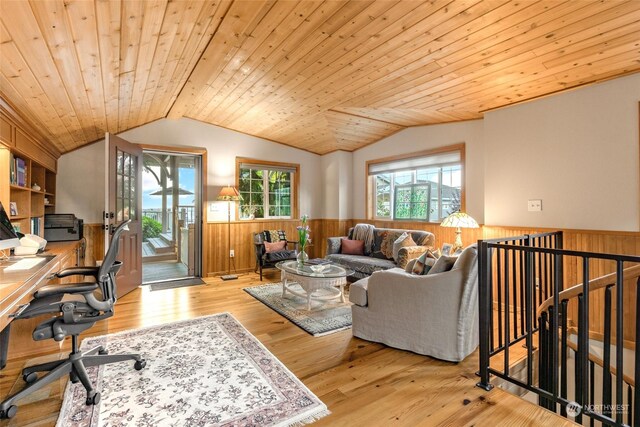 living room with light wood-type flooring, lofted ceiling, wood walls, and wooden ceiling