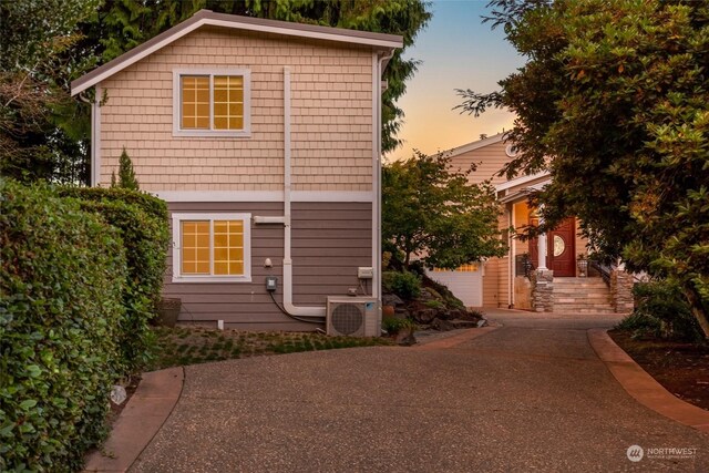 property exterior at dusk with ac unit