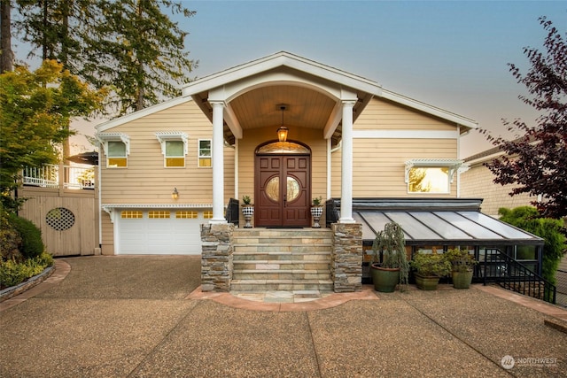 view of front of house with driveway, a standing seam roof, and a garage