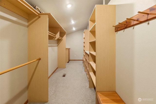 spacious closet with light colored carpet and visible vents