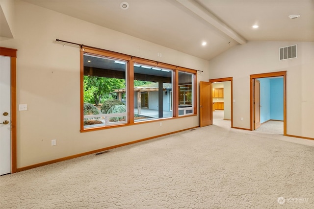 spare room with carpet floors and vaulted ceiling with beams