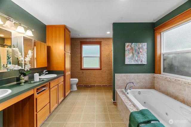 full bathroom featuring toilet, a sink, visible vents, a whirlpool tub, and double vanity