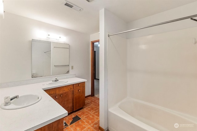 bathroom featuring tile patterned floors, visible vents, vanity, and bathing tub / shower combination