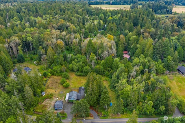 drone / aerial view with a wooded view