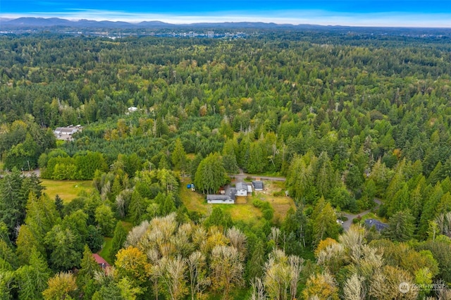 drone / aerial view with a forest view and a mountain view