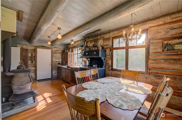 dining room featuring wood ceiling, an inviting chandelier, light hardwood / wood-style floors, and beamed ceiling