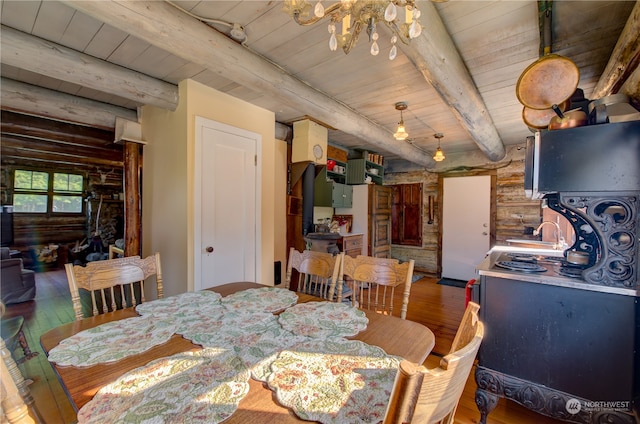 dining room featuring beamed ceiling, wooden ceiling, and hardwood / wood-style flooring