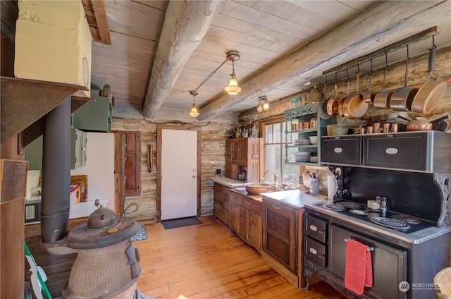 kitchen with light wood-type flooring, wood ceiling, decorative light fixtures, and beam ceiling