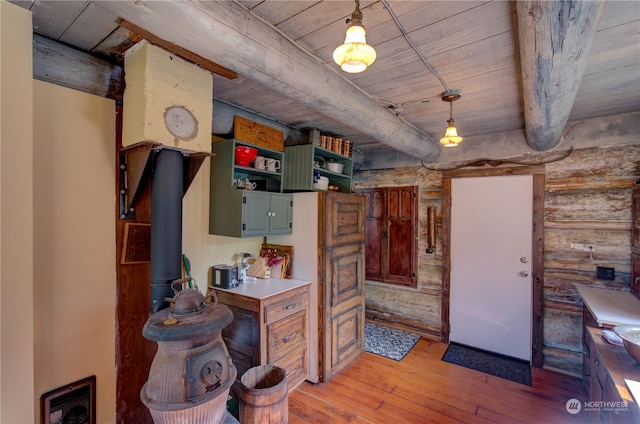 kitchen featuring pendant lighting, beamed ceiling, wooden ceiling, and light hardwood / wood-style flooring