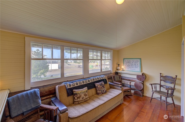 living room with a wealth of natural light, vaulted ceiling, hardwood / wood-style floors, and wooden ceiling