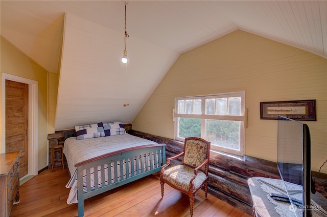 bedroom featuring lofted ceiling and hardwood / wood-style floors