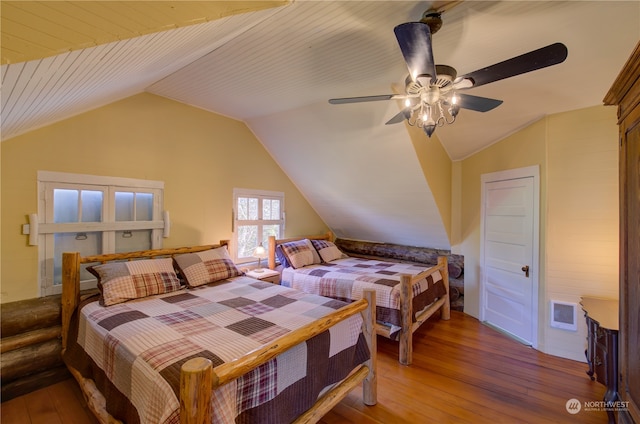 bedroom with ceiling fan, vaulted ceiling, and hardwood / wood-style flooring