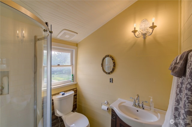 bathroom featuring lofted ceiling, vanity, toilet, and walk in shower