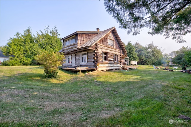 exterior space featuring a deck and a front lawn