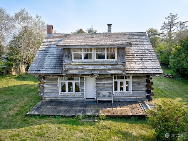 back of property with a yard and french doors