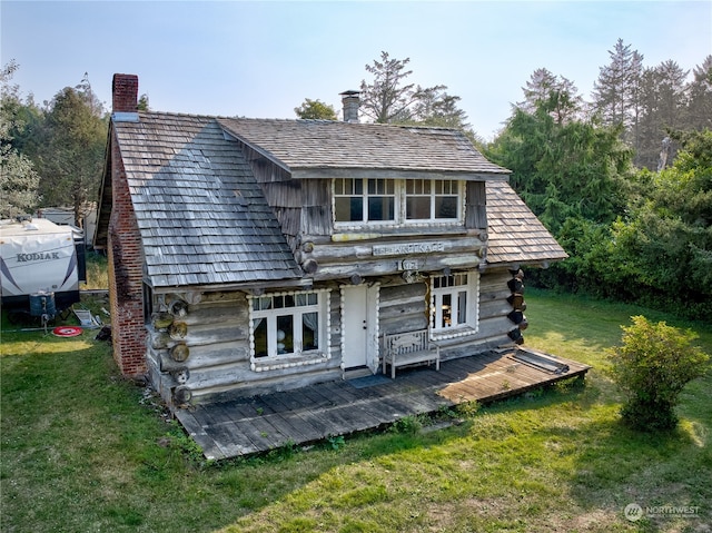 back of property with french doors and a yard