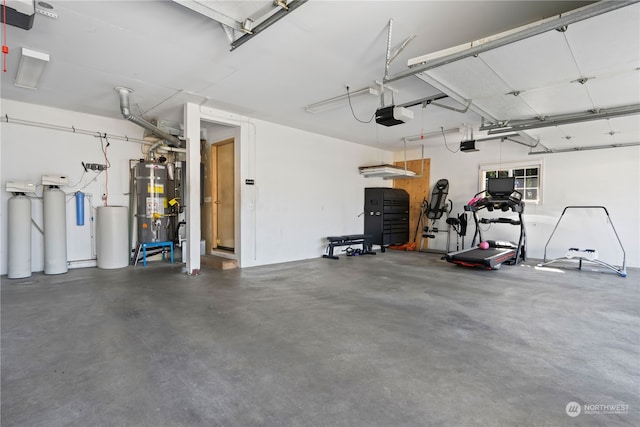 garage featuring a garage door opener and water heater