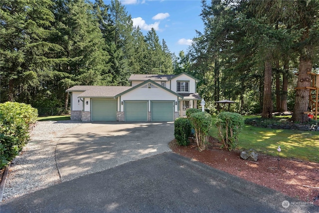 view of front facade with a garage and a front lawn