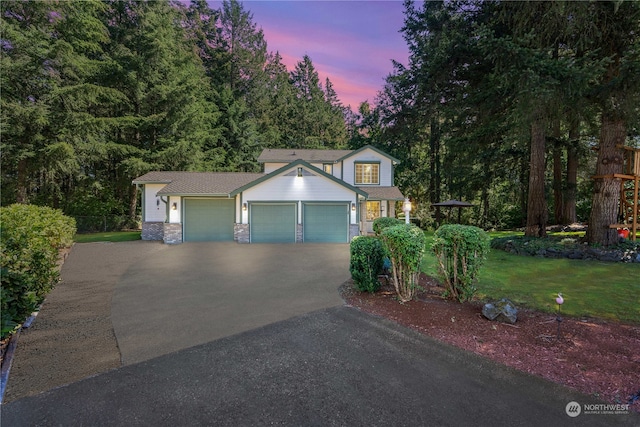 view of front of property featuring a yard and a garage