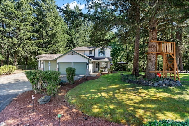 view of front of house featuring a garage and a front lawn