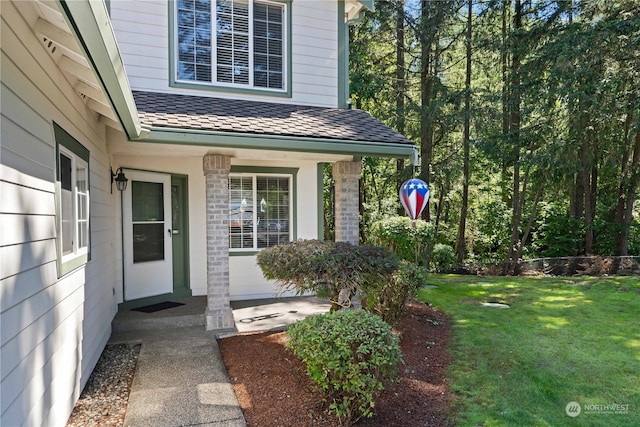 doorway to property with a lawn