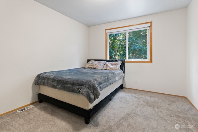 bedroom with light colored carpet