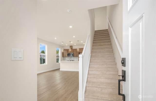 stairs featuring hardwood / wood-style flooring